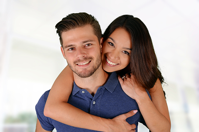 Man and woman posing together inside their home